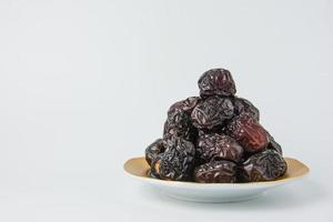 Delicious ajwa dates kurma nabi, Much sought after during the month of Ramadan as a dish for breaking the fast, ramadhan kareem, empty space, copy space. photo