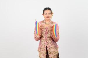 Young beautiful woman dress up in local culture in southern region with rainbow flag photo