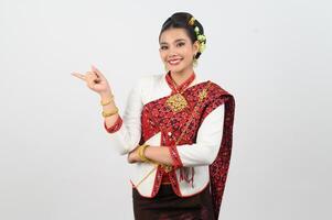 Young beautiful woman in northeastern dress stand and point finger posture photo