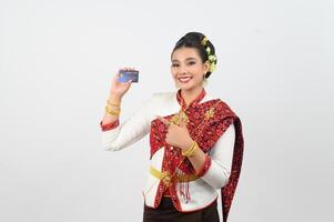 Portrait of Beautiful Thai Woman in Traditional Clothing Posing with credit card photo