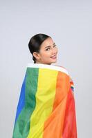 Pretty woman LGBQ pose with muli-color flag photo