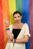 Pretty woman LGBQ pose with muli-color flag photo