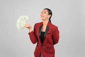 Young beautiful woman in formal clothing for officer with banknote in hands photo