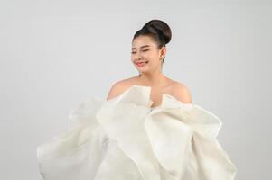 Young asian beautiful bride smiling with happy on white background photo