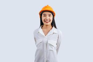 Young female engineer wearing yellow helmet stand with charming smile posture photo