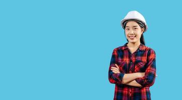 Young female engineer wearing yellow helmet stand with charming smile posture photo