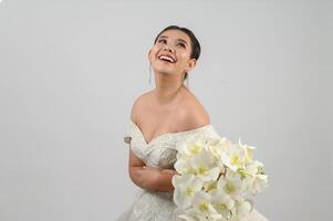 Young asian beautiful bride pose with excited feel on white background photo