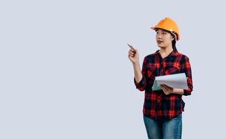 Young female engineer wearing Yellow helmet and clipboard photo