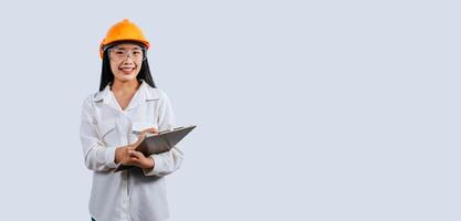 Young female engineer wearing Yellow helmet and safety eyeglasses photo