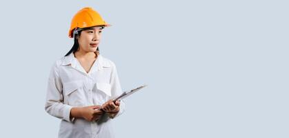 Young female engineer wearing Yellow helmet and clipboard photo