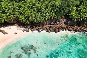 Drone shot of intendance beach on a hot sunny day, turquoise ocean and palm trees photo