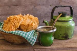 mate and kettle, traditional Argentine yerba mate infusion, on rustic wooden background photo