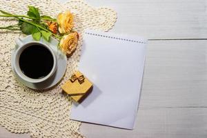 coffee with roses and gift on the rustic table photo