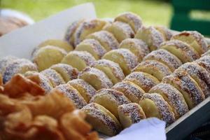 alfajores fried cakes and churros for sale at the street fair photo