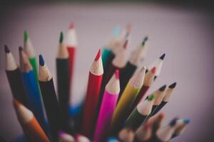 pencils in cup on white table photo