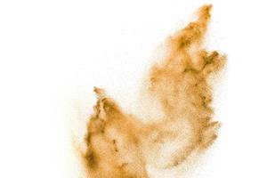 Brown sand explosion isolated on white background. Abstract sand cloud backdrop. photo