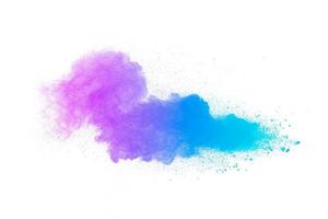 Multi colour powder explosion on white background. Launched colourful dust particles splashing. photo