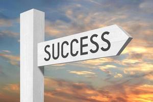 Success - White Wooden Signpost with one Arrow and Sunset Sky in Background photo