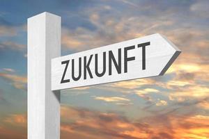 Future in German - White Wooden Signpost with one Arrow and Sunset Sky in Background photo