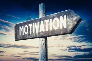 Motivation - Wooden Signpost with one Arrow, Sunset Sky in Background photo