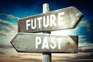 Future, Past - Wooden Signpost with Two Arrows, Sunset Sky in Background photo