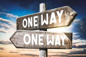 One Way - Wooden Signpost with Two Arrows, Sunset Sky in Background photo