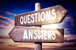 Questions, Answers - Wooden Signpost with Two Arrows, Sunset Sky in Background photo