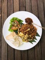 Fried rice, shredded omelet and satay is traditional food in Indonesia photo