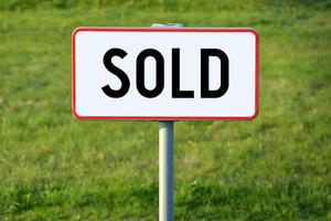 Sold - White Sign on a Grass photo