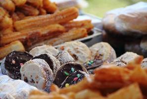 alfajores fried cakes and churros for sale at the street fair photo