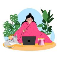 Young woman sitting in a pink blanket and watching a movie on laptop. House plant on background. Chilling at home concept.