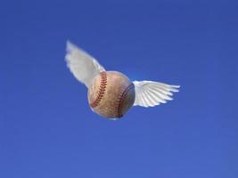 Baseball ball shot in the air with blue sky background photo