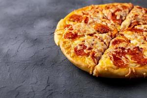 Tasty hot homemade pepperoni pizza. Traditional classic pizza with salami and cheese. With copy space for text. photo