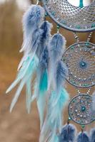 Handmade dream catcher with feathers threads and beads rope hanging photo