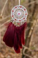 Handmade dream catcher with feathers threads and beads rope hanging photo