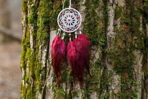 Handmade dream catcher with feathers threads and beads rope hanging photo