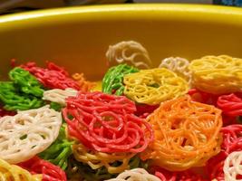 A close up of raw buckwheat crackers or kerupuk mentah with various colors photo
