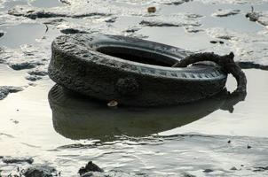 Car tire pollution at coastal photo