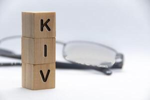 KIV text engraved on wooden blocks with white cover background. Keep in view concept. Copy space photo