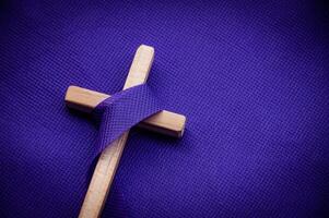 Religious cross on purple background. Good Friday concept photo