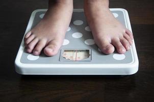 Straight view of feet on weight scale . Weight loss concept. photo