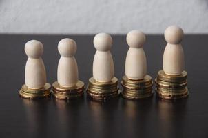 Coins Stack with wooden doll model - Business Concept photo