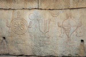 Vaishnavism icons on stone donation box at Krishna temple in Hampi photo