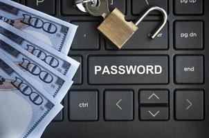 Password text on laptop tab with locker and bank notes background. photo