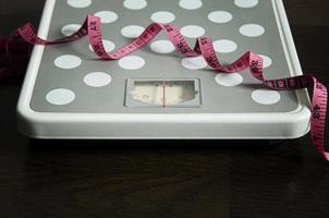 Straight view of weight scale and measuring tape. Weight loss concept. photo
