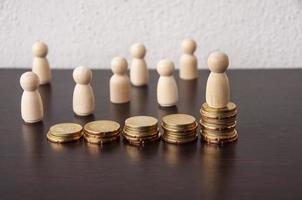Coins Stack with wooden doll model background - Business Concept photo