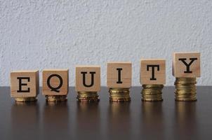 Coins Stack with Equity text on wooden blocks - Business Concept photo