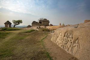 Ruins on Hemakuta Hill in Hampi and carvings of Ram Laxman and Sita on rocks photo