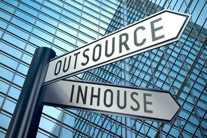 Inhouse and Outsource - Signpost With Two Arrows, Office Building in Background photo