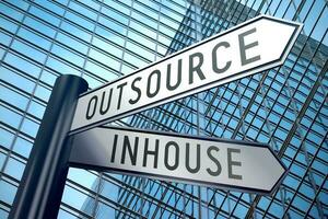 Inhouse and Outsource - Signpost With Two Arrows, Office Building in Background photo